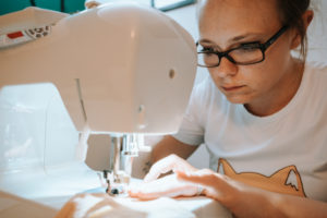 Woman sewing face mask for corona covid pandemic with sewing machine, Woman sewing face mask for corona covid pandemic with sewing machine,